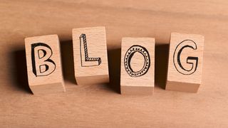 The word 'blog' written on wooden blocks to represent learning how to start a blog