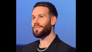 man with a beard and a pearl necklace on a blue background